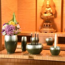 Japanese-made stainless steel green Buddhist altar set, including a vase, flower vase, candle holder, incense burner, rice bowl, teacup, and incense holder. 