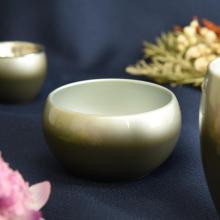 Japanese-made stainless steel green Buddhist altar set, including a vase, flower vase, candle holder, incense burner, rice bowl, teacup, and incense holder. 